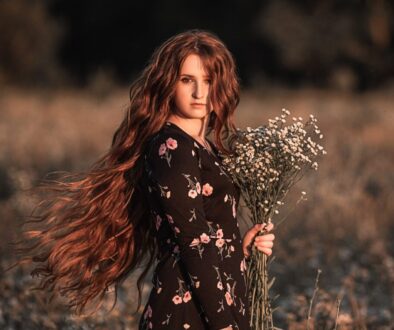 Young woman in autumn flower field