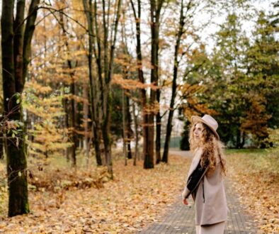 Woman Walking in a Park in Autumn