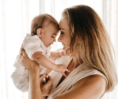 smiling woman carrying baby