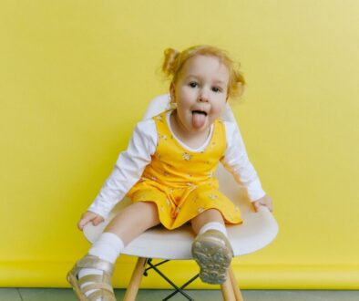Girl in White And Yellow Long Sleeve Dress Doing Funny Face