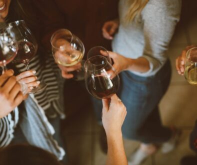 group of people tossing wine glass