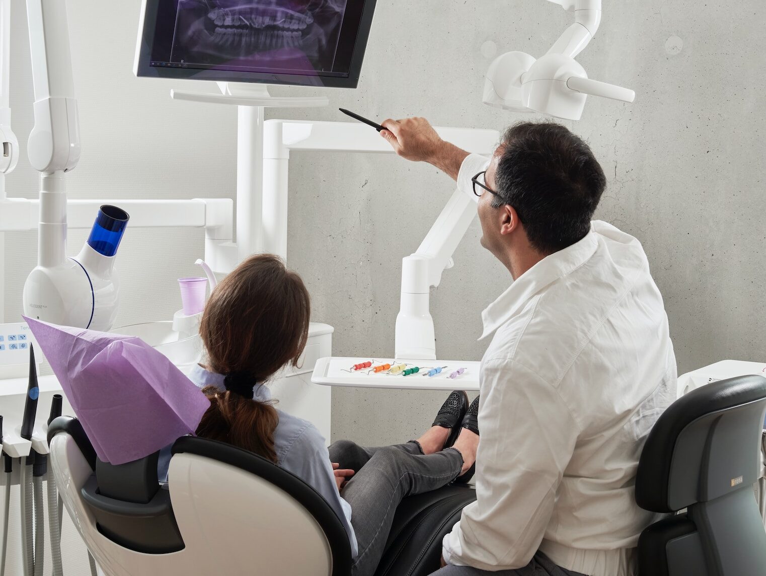man in white dress shirt holding black pen