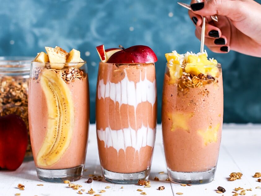 three clear drinking glass filled by shakes