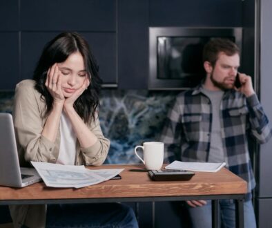 Woman in White Long Sleeve Shirt Sitting Beside Man in Black and White Checkered Dress Shirt