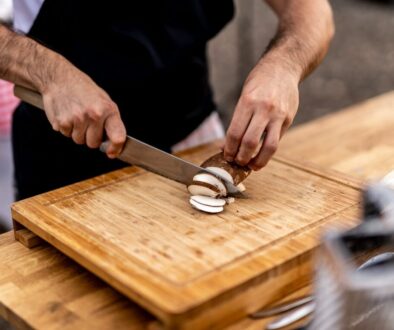 a man is cutting onions on a cutting board