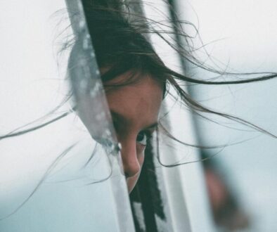 girl sticking her head in car of window