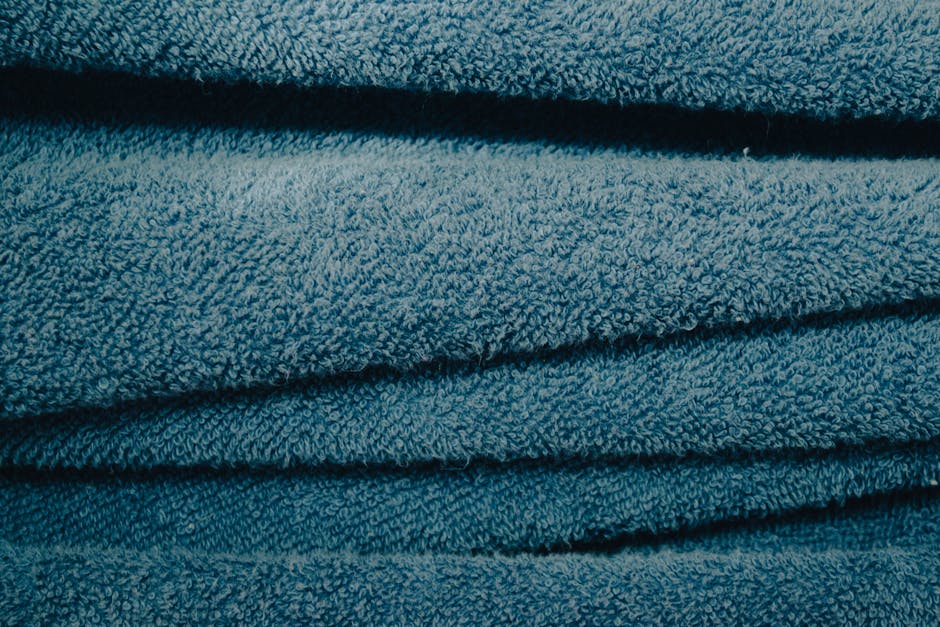 Detailed view of soft blue towels showcasing texture and fabric pattern.