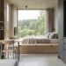 Open-plan studio with a wooden bed platform facing a forest view through large windows; kitchenette to the right.