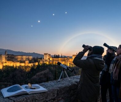 Group of four people on a stone viewpoint, gazing through binoculars at the Alhambra glowing at dusk, with a telescope, an open astronomy book, and a compass on the wall.