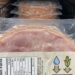 Pre-packaged sliced ham in a vacuum-sealed tray with a nutrition facts label visible on the front.