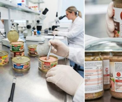 Food laboratory scene with gloved hands scooping pâté from several open canned meats on a stainless workbench; microscopes in the background.